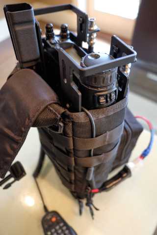 Yaesu 857D portable kit shown from another angle.  A closeup of the CW relocation cable is shown.  The cable comes out the top of the bag, and is threaded down through the loops of the PALS webbing on the radio pouch.
